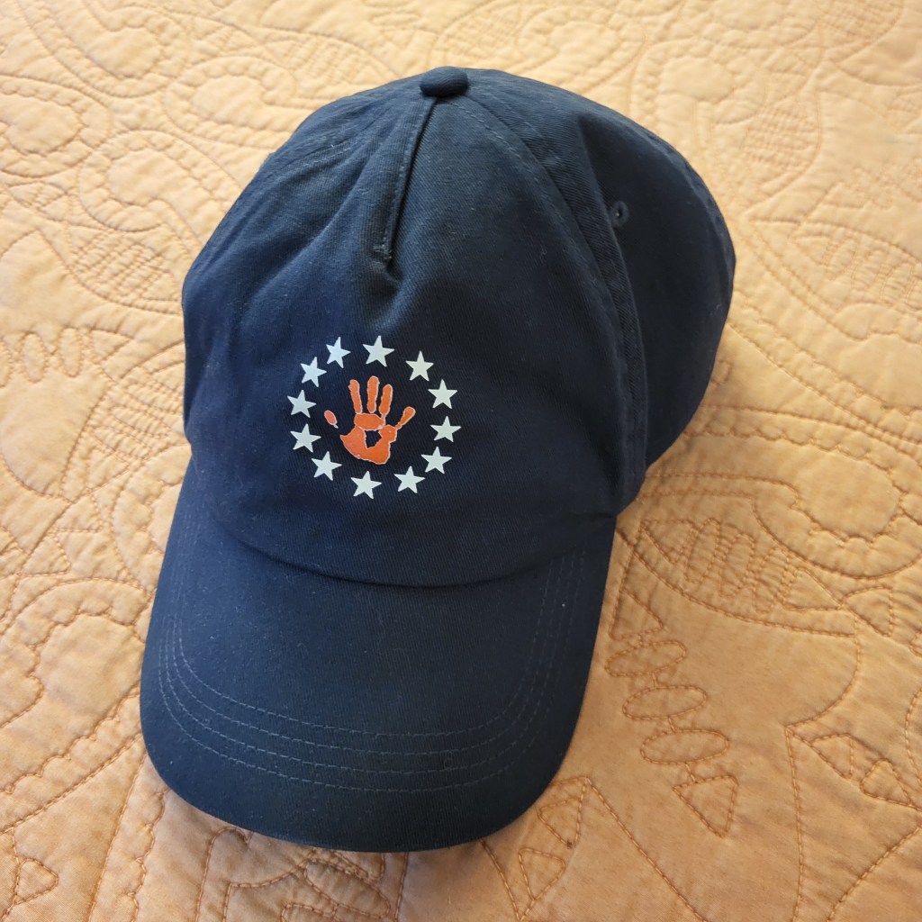 navy ballcap with red hand regiment logo